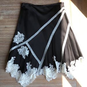 Black and white silk skirt with flower detail.